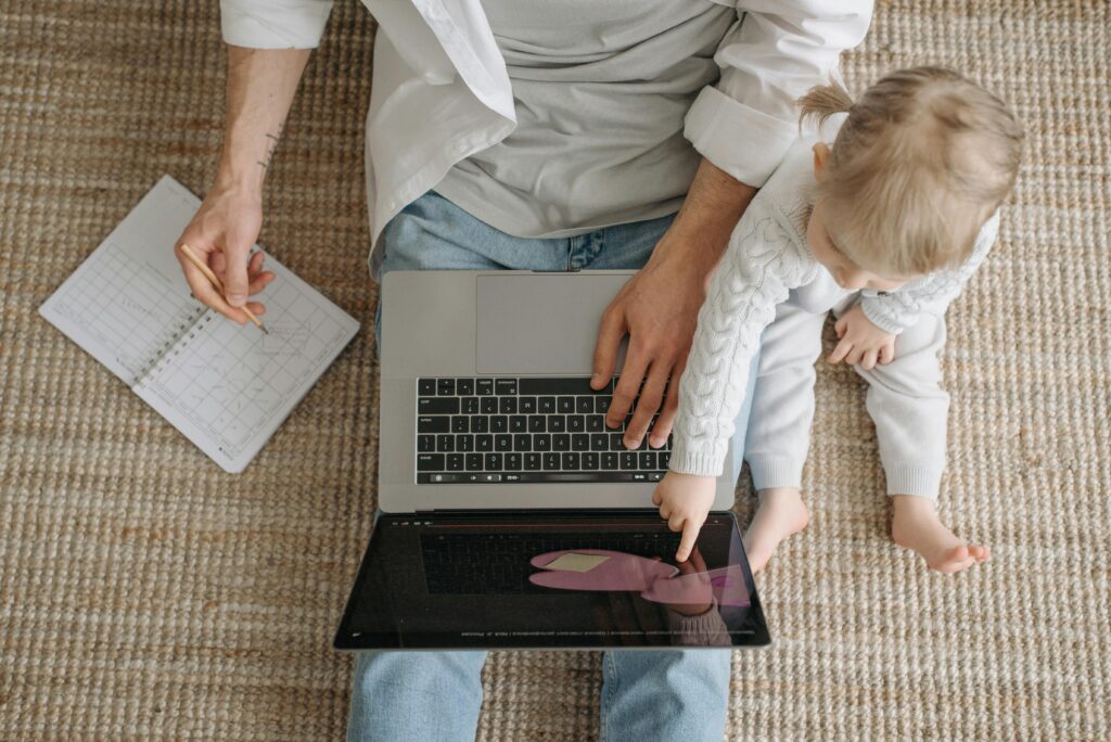 Parents sitting together, looking at a list of baby names or a notebook.